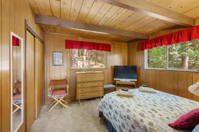 a bedroom with a bed and a tv in it at Walk to Fly-In Lake Blue Lake Springs Cabin! in Arnold