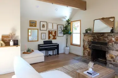 a living room with a fireplace and a piano at Walk to Lake 4BR Memory Making Alpine Retreat in Tahoe City