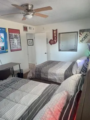 a bedroom with two beds and a ceiling fan at Franklin Apt in Fresno