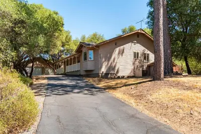 a house with a tree and a driveway at Groveland 2BR Home - Mountain Retreat in Groveland