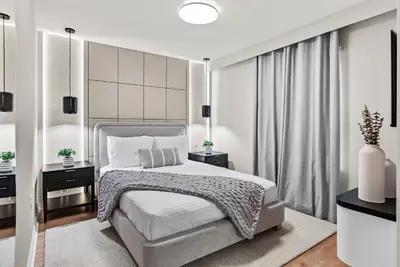 a white bedroom with a bed and a window at NEW 10BD At Windsor Cay Pool and Game Room