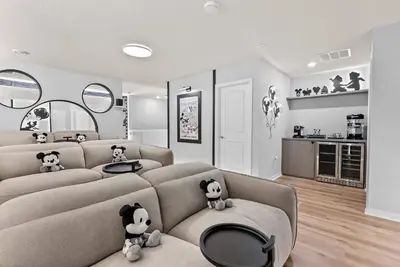 a living room with a couch with stuffed animals on it at NEW 10BD At Windsor Cay Pool and Game Room