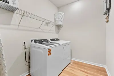 a laundry room with a washer and dryer in a room at NEW 10BD At Windsor Cay Pool and Game Room