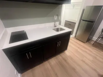 a kitchen with a sink and a refrigerator at Value Suites Extended Stay in Sacramento