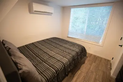 a small bedroom with a bed and a window at Tiny Blue at Yosemite Gateway in Groveland