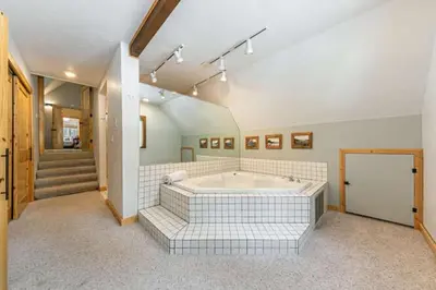 a large bathroom with a tub in a room at Lakewalk Lodge at the West Shore by Tahoe Getaways, Pet-Friendly w Sauna! in Homewood