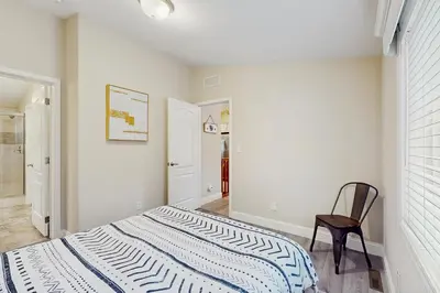 a bedroom with a bed and a chair in it at Sierra Solace in South Lake Tahoe