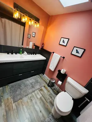 a bathroom with a white toilet and a sink at Fun for 2-Hot Tub-Dogs Ok-Near Bass Lake in Oakhurst