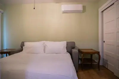 a bed with white sheets and pillows in a room at Buckeye Basecamp-Events-Family Friendly-Creek in Sonora