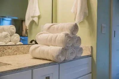 a stack of towels on a counter in a bathroom at Buckeye Basecamp-Events-Family Friendly-Creek in Sonora