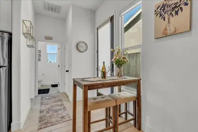 a dining room with a table and a clock on the wall at Peaceful Guest Casita with Private Entrance and No Cleaning Fee in Hanford