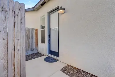 a sliding glass door on a building with a fence at Peaceful Guest Casita with Private Entrance and No Cleaning Fee in Hanford