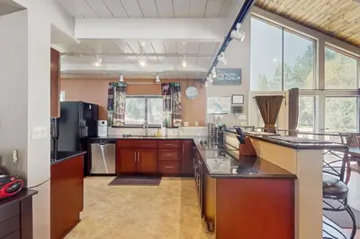 a large kitchen with wooden cabinets and stainless steel appliances at Paradise Place in Groveland