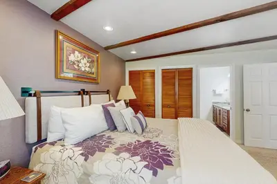 a bedroom with a large bed with pillows at Paradise Place in Groveland