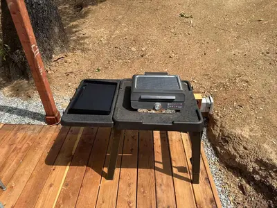 a grill sitting on top of a wooden deck at The Falls-Overlooks a waterfall-BBQ-Sleeps 4 in Oakhurst
