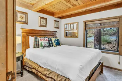 a bedroom with a large bed and a window at Peaceful Getaway Pet Friendly with Hot Tub and Grill in Tahoe City