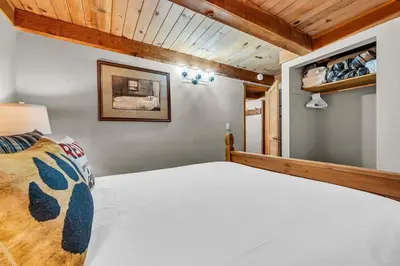 a bedroom with a white bed and wooden ceilings at Peaceful Getaway Pet Friendly with Hot Tub and Grill in Tahoe City