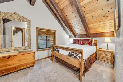 a bedroom with a bed and a mirror at Peaceful Getaway Pet Friendly with Hot Tub and Grill in Tahoe City