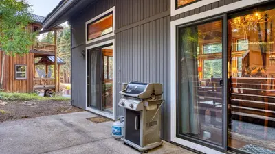 a barbecue grill sitting outside of a house at Cozy Escape w Hot Tub Deck Access to Tahoe Donner Skiing Alpenglow Chalet by AvantStay in Truckee