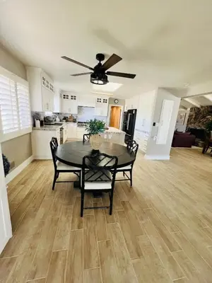 a dining room with a table and a kitchen at Villa Luxury Family Getaway in Patterson