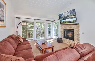 a living room with a couch and a fireplace at St Anton Condo in Mammoth Lakes! in Mammoth Lakes