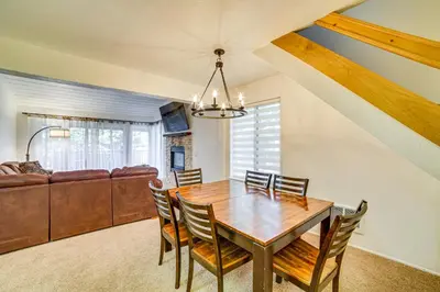 a dining room with a table and chairs and a couch at St Anton Condo in Mammoth Lakes! in Mammoth Lakes