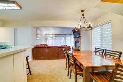 a kitchen and dining room with a wooden table and chairs at St Anton Condo in Mammoth Lakes! in Mammoth Lakes