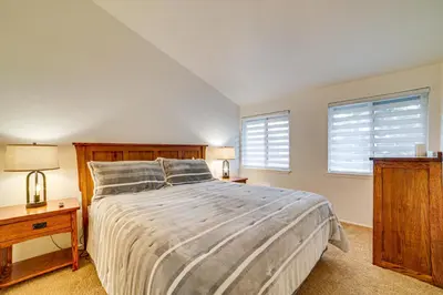 a bedroom with a large bed and two windows at St Anton Condo in Mammoth Lakes! in Mammoth Lakes