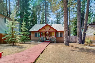 a small house in the middle of a forest at Tata Cabin in South Lake Tahoe