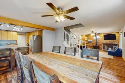 a dining room with a table and a ceiling fan at Tata Cabin in South Lake Tahoe
