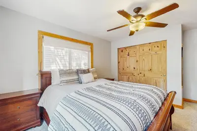 a bedroom with a bed and a ceiling fan at Tata Cabin in South Lake Tahoe