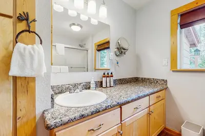 a bathroom with a sink and a mirror at Tata Cabin in South Lake Tahoe