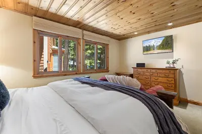 a bedroom with a white bed and a wooden ceiling at Luxury 4BR Retreat Near Northstar Sleeps 10 in Tahoe Vista
