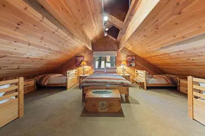 a bedroom in a log cabin with a bed and a table at Luxury 4BR Retreat Near Northstar Sleeps 10 in Tahoe Vista