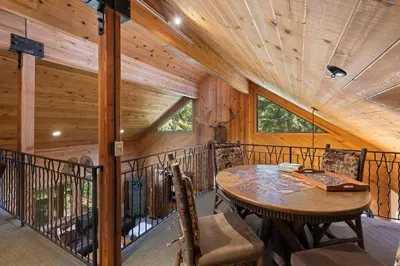 a room with a table and chairs on a balcony at Luxury 4BR Retreat Near Northstar Sleeps 10 in Tahoe Vista