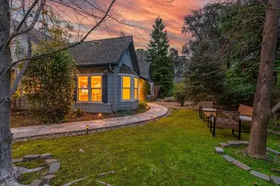 a small house in a yard with benches at The Blue Resort of Yosemite - Pool, Spa, Games in Mariposa