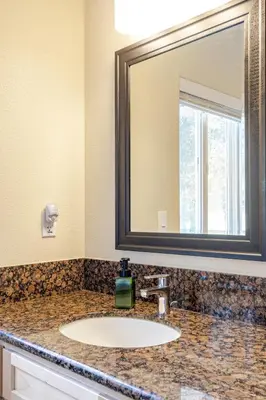 a bathroom with a sink and a mirror at Beautiful Lake Views with Hot Tub and Space for Family in Oakhurst