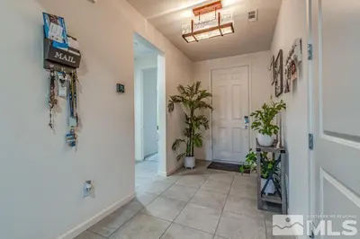 a hallway with potted plants and a white door at Peaceful Private Room in Sparks in Sparks