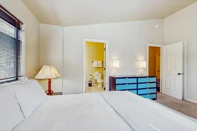 a bedroom with a white bed and a blue dresser at My Tahoe Sanctuary in South Lake Tahoe
