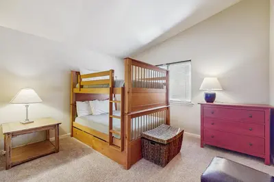 a bedroom with two bunk beds and a dresser at My Tahoe Sanctuary in South Lake Tahoe