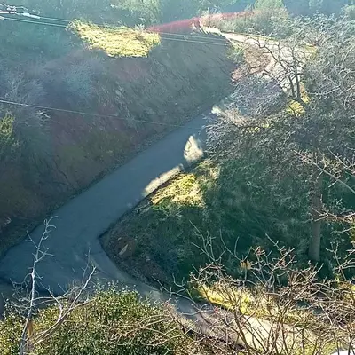an aerial view of a winding road in a field at Secluded Oasis with View, and hot tub on 50 acres in Bodfish