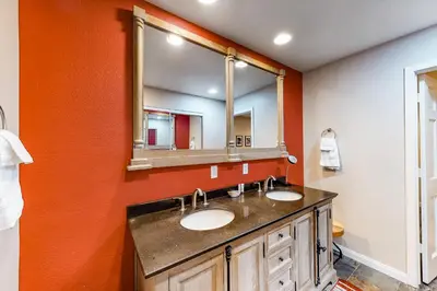 a bathroom with two sinks and a large mirror at Meadow Ridge 37 in Mammoth Lakes