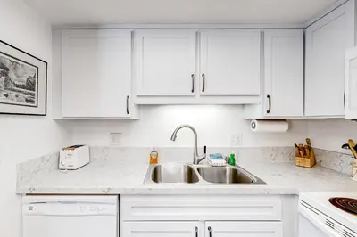 a kitchen with white cabinets and a sink at La Vista Blanc 19 in Mammoth Lakes