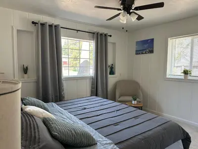a bedroom with a bed and a ceiling fan at Suite E with 2-bedroom in Sacramento