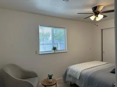 a bedroom with a ceiling fan and a bed and a window at Suite E with 2-bedroom in Sacramento