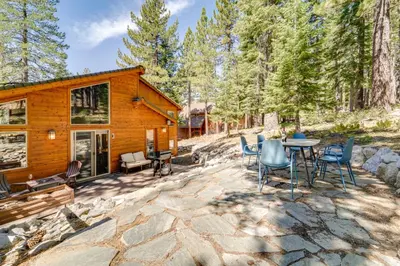 a cabin in the woods with a table and chairs at Near Ski Resorts and Trails Truckee Home with Hot Tub in Truckee