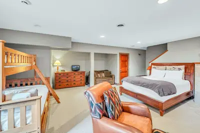a bedroom with a bunk bed and a couch and a chair at South Tahoe Haven Views Comfort Fun in South Lake Tahoe