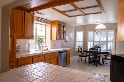 a kitchen and dining room with a table and chairs at Modern Merced Haven near Merced College and UC Merced in Merced