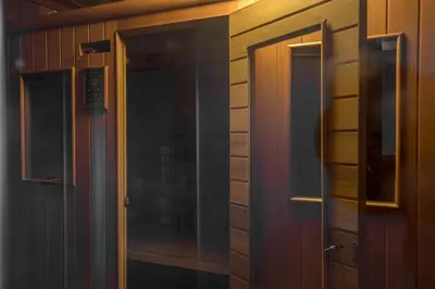 a glass door in a room with a wooden wall at Mammoth Basecamp Condo with Views near Village with AC and Fireplace in Mammoth Lakes