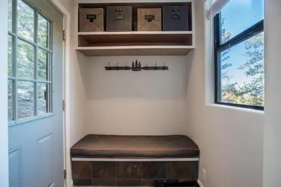 a room with a bench next to a door at Mammoth Basecamp Condo with Views near Village with AC and Fireplace in Mammoth Lakes